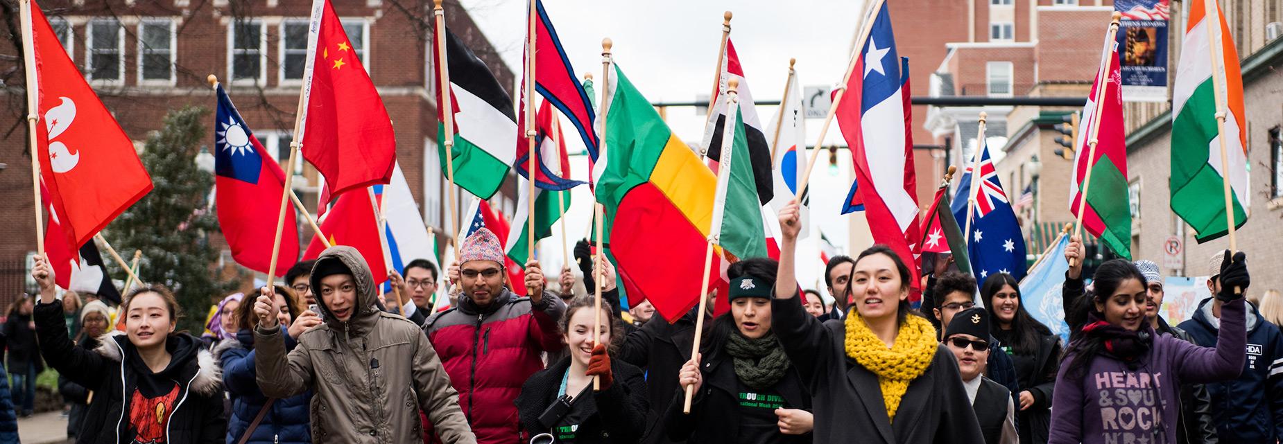 students carrying flags of many nations