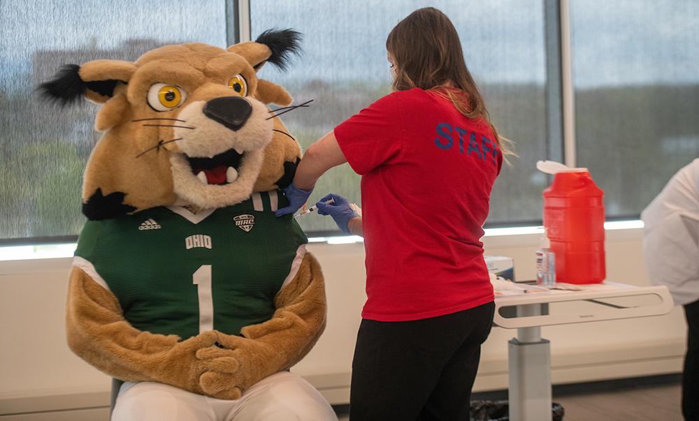 Nurse vaccinated Bobcat mascot