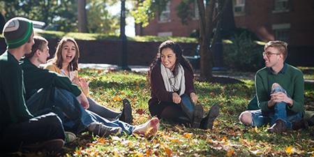 Group of students sit on college green