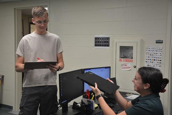 Two OIT student employees working on-site.