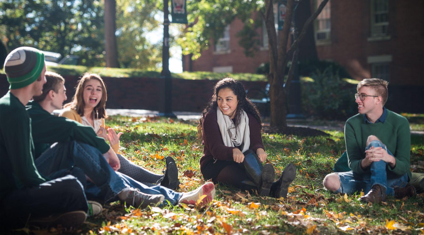 Students sit on College Green