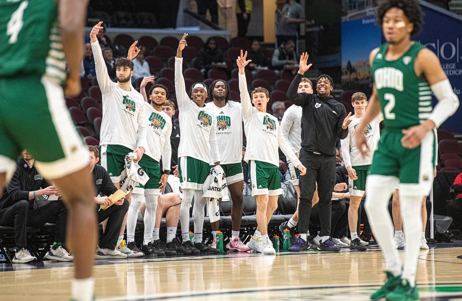 Members of the Ohio basketball team cheer from the bench after a made three pointer. 