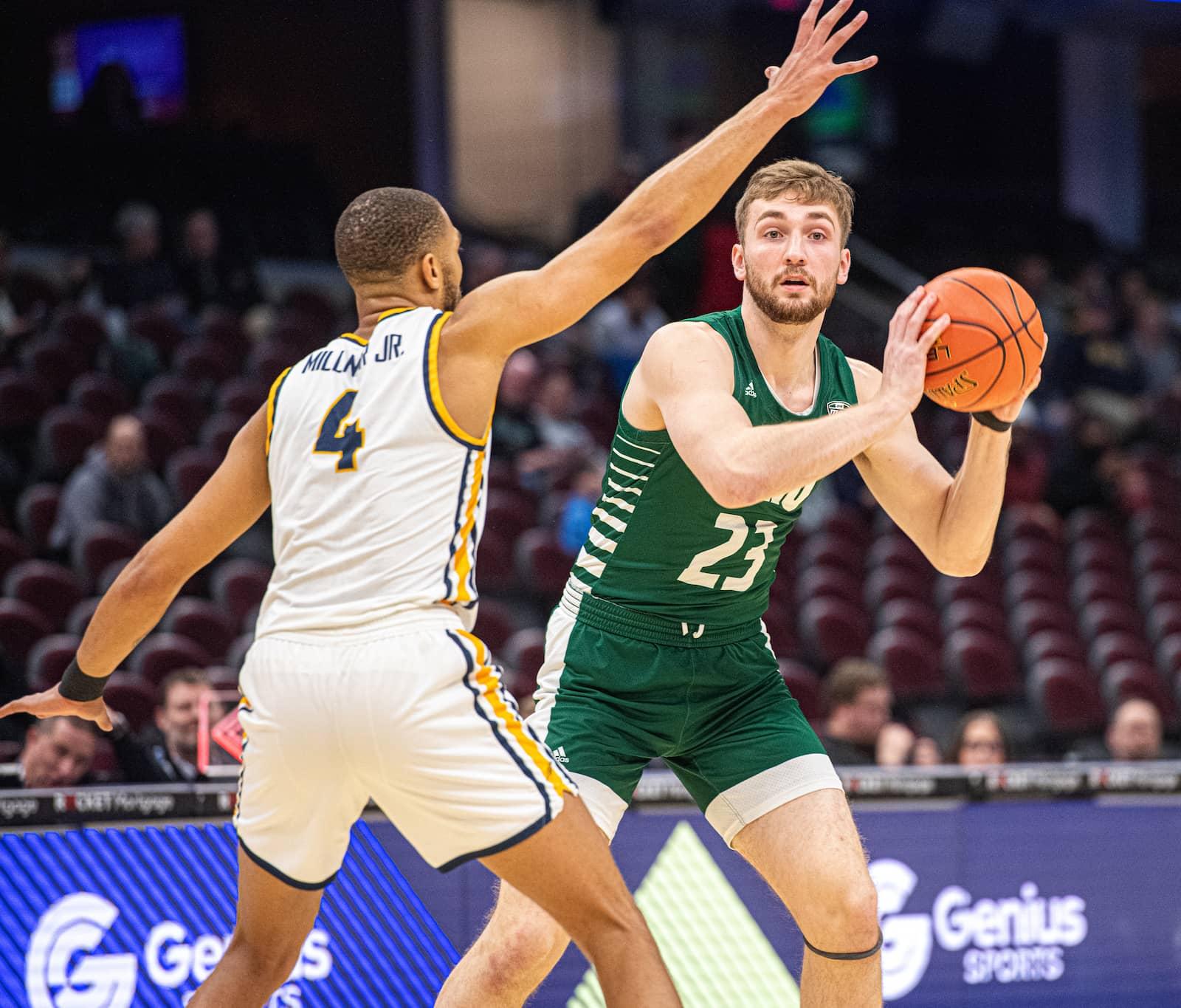 Ohio sophomore forward AJ Clayton looks for a teammate to pass the ball to during Ohio’s 82-75 semifinal loss to Toledo. 