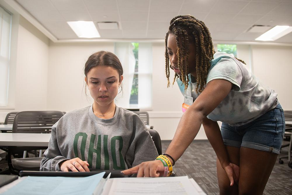 BSO leader helping a student at a desk