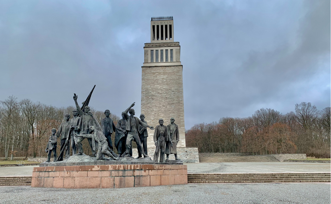 Image of labor camp memorial with tower and statue.