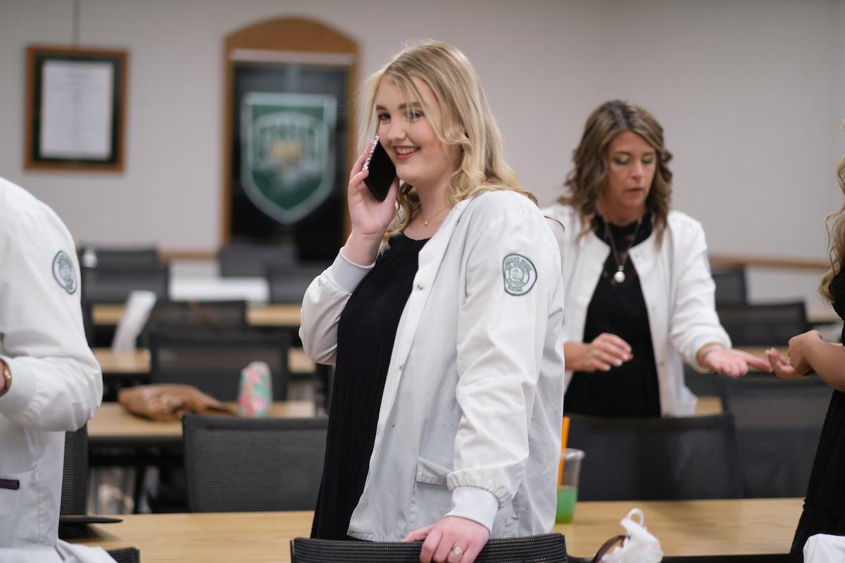 Nursing grad talking on phone in caucus room