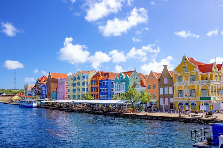 Colorful buildings along waterway.