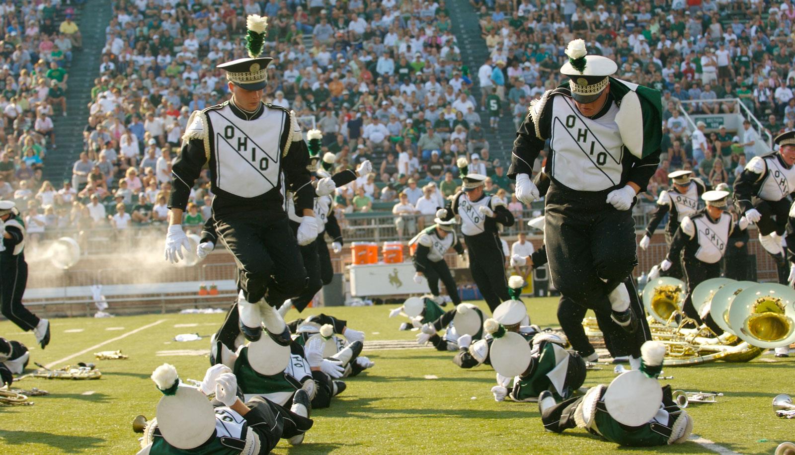 The Marching 110 perform their halftime routine at a football game