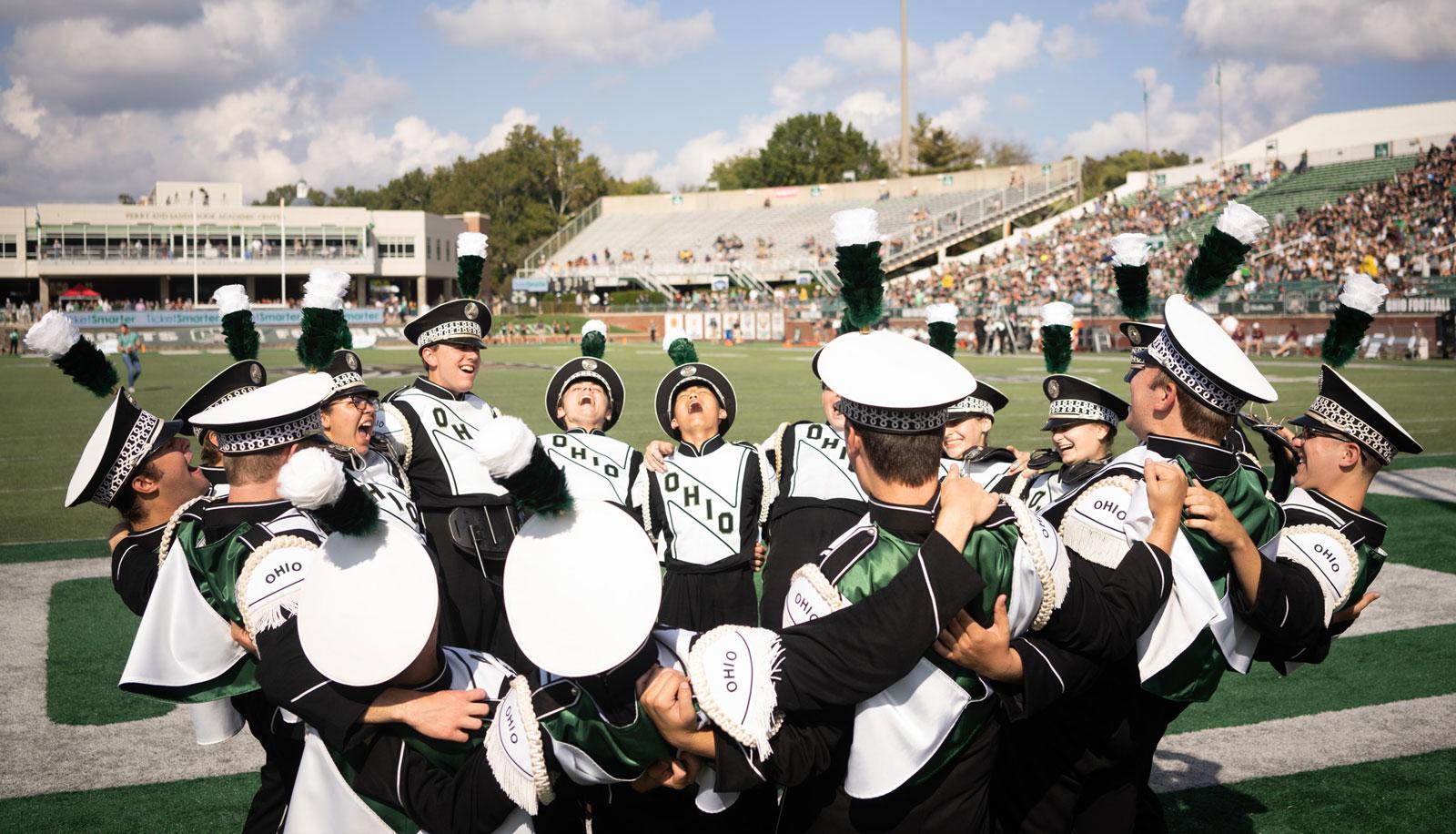 Members of The Marching 110 gather on the field before the homecoming game