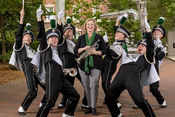 President Gonzales poses for a photo with some mebers of the Marching 110.