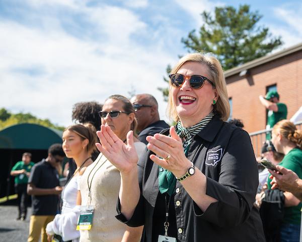 President Gonzalez cheers at a football game.