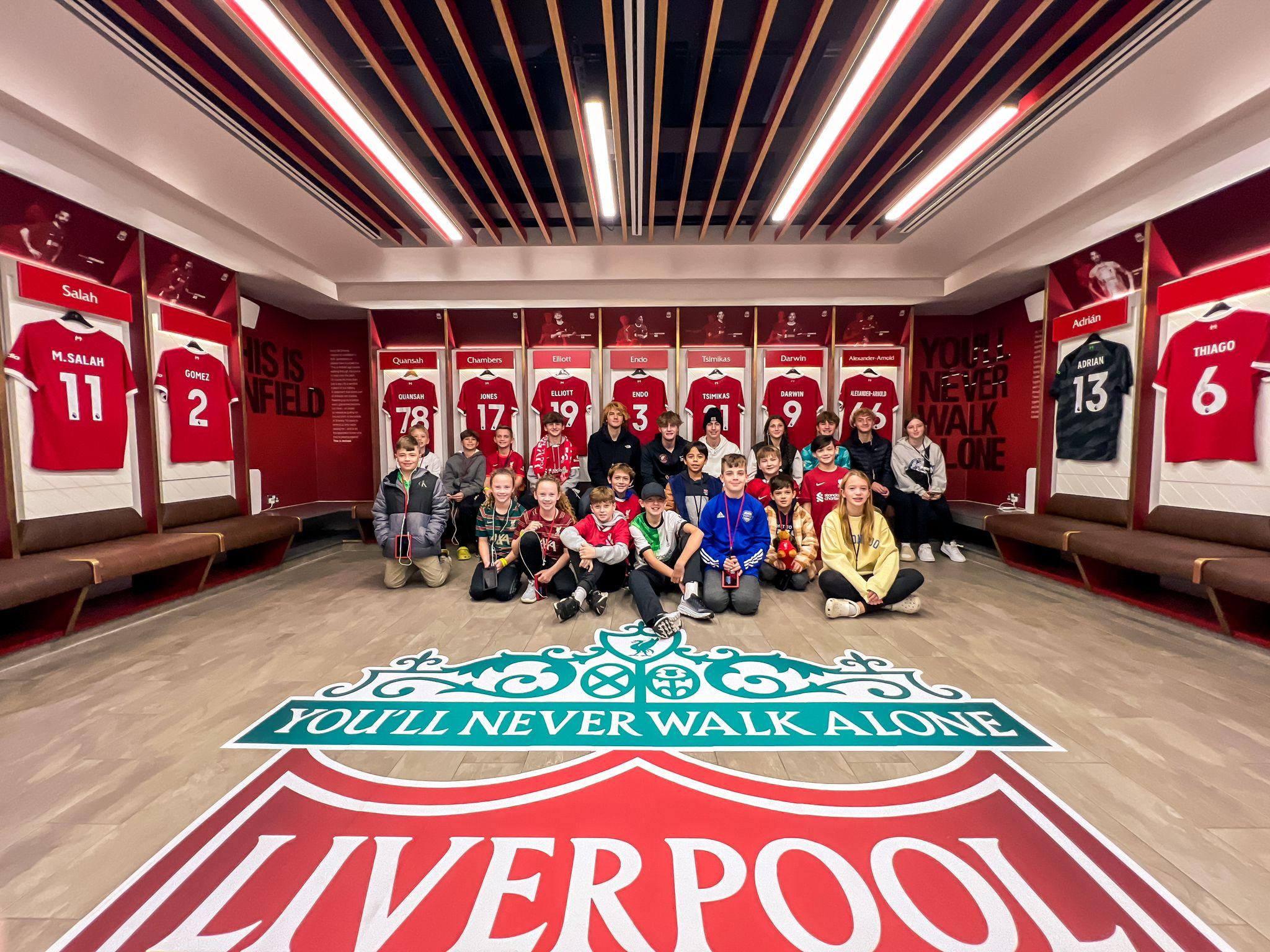 Group photo in Liverpool locker room. 