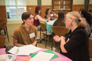 Two people talking at a table