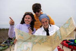 Students look at a map for directions