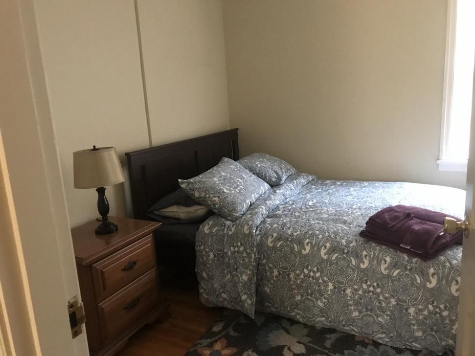 Bedroom with twin bed and window on one wall