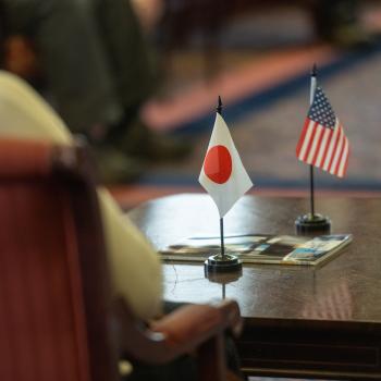 Photo of a small Japan flag and US flag on a table
