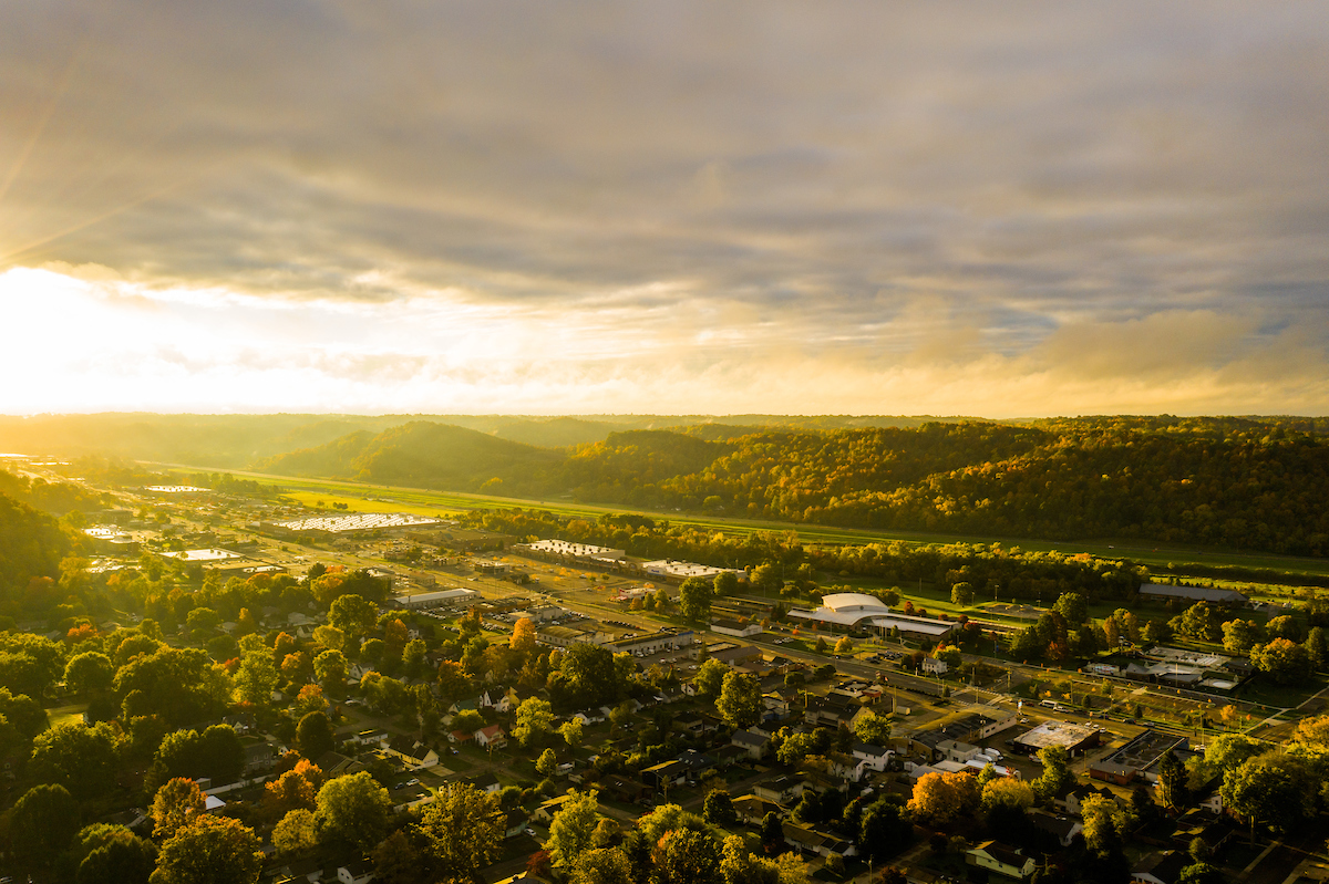 Aerial photo of the sun gracing the hills of Athens, Ohio