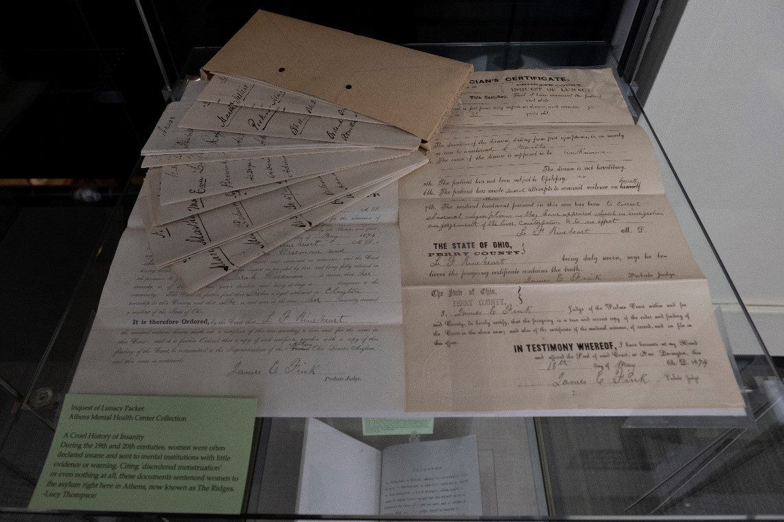 A photo of intake forms from the former Ridges Asylum. The forms are on display at Alden Library.
