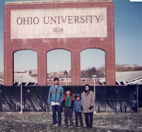 Dr. Zainuriah Hassan and her children in front of Peden stadium