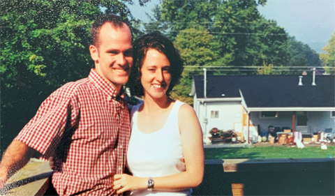 Dr. Aaron Reid and his wife outside their home in Athens