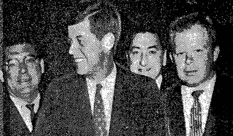 James Parobek standing behind President John F. Kennedy in a newspaper photo