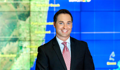 Ryan Phillips in front of a weather map