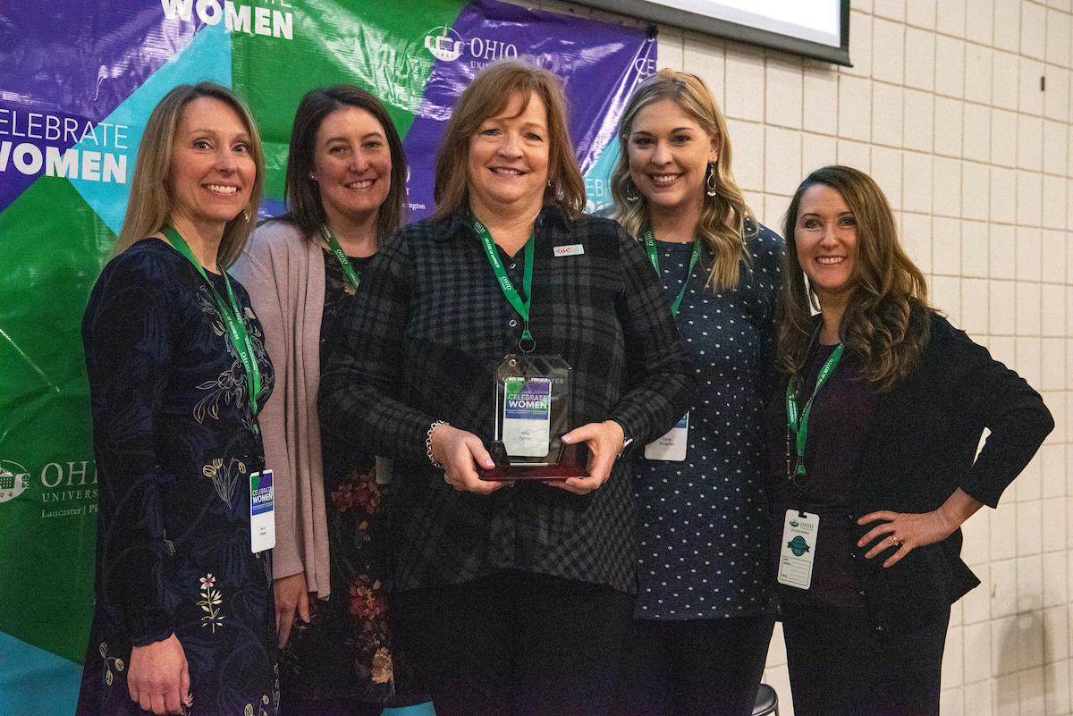 Amy Eyman is shown holding the Jane Johnsen Vision for Women Award with others at the Celebrate Women conference