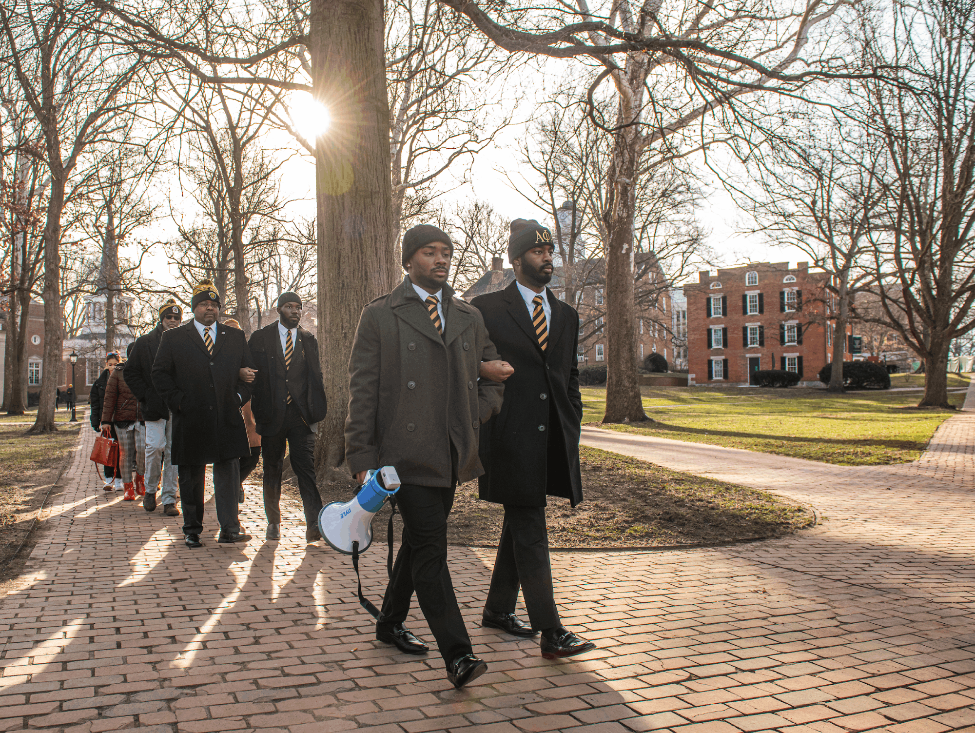 Students lead a silent procession across College Green in honor of Martin Luther King Jr.