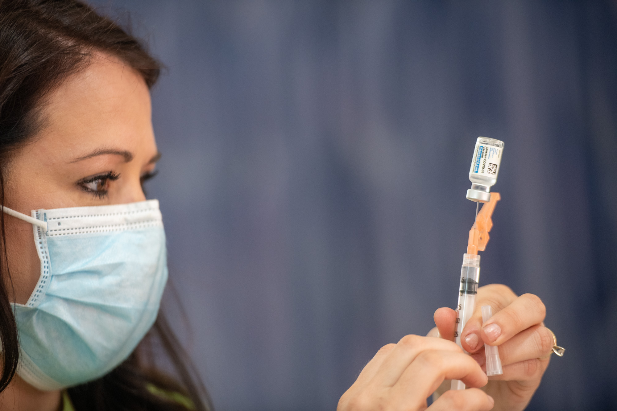 A hypodermic needle is prepared with liquid from a vial