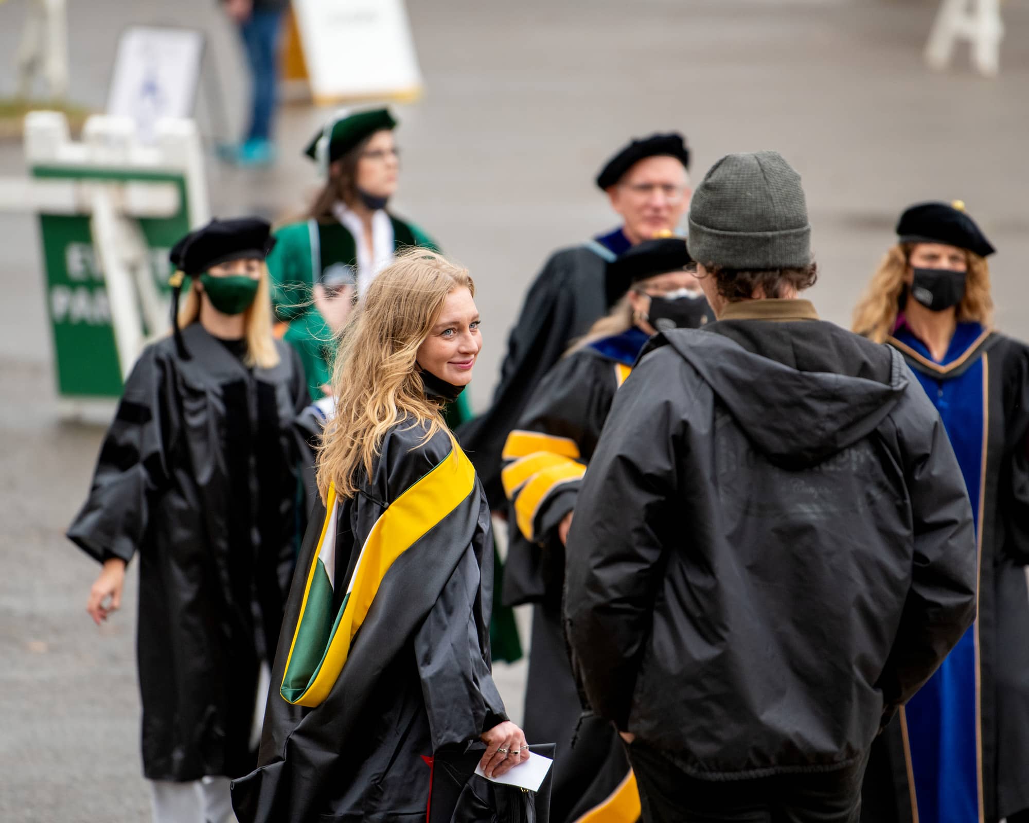Ryanne Celeste, left, makes her way to the Convocation Center with her partner Chris Seymour, right, prior to the Fall Commencement 2021 at the Athens Campus.
