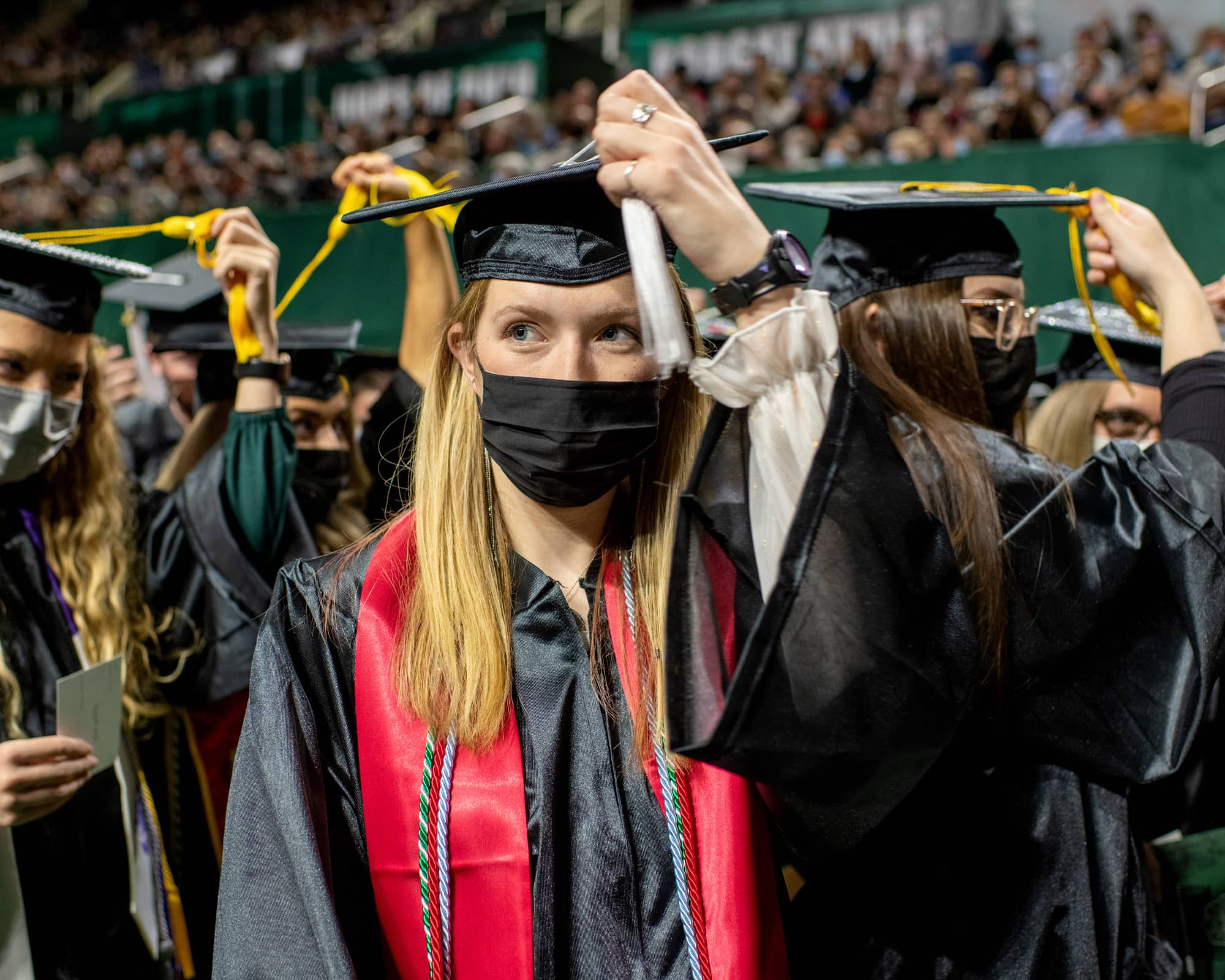 Undergraduate students move their tassels from the right to the left to signify they have officially graduated during the Fall Commencement 2021 at the Athens Campus.