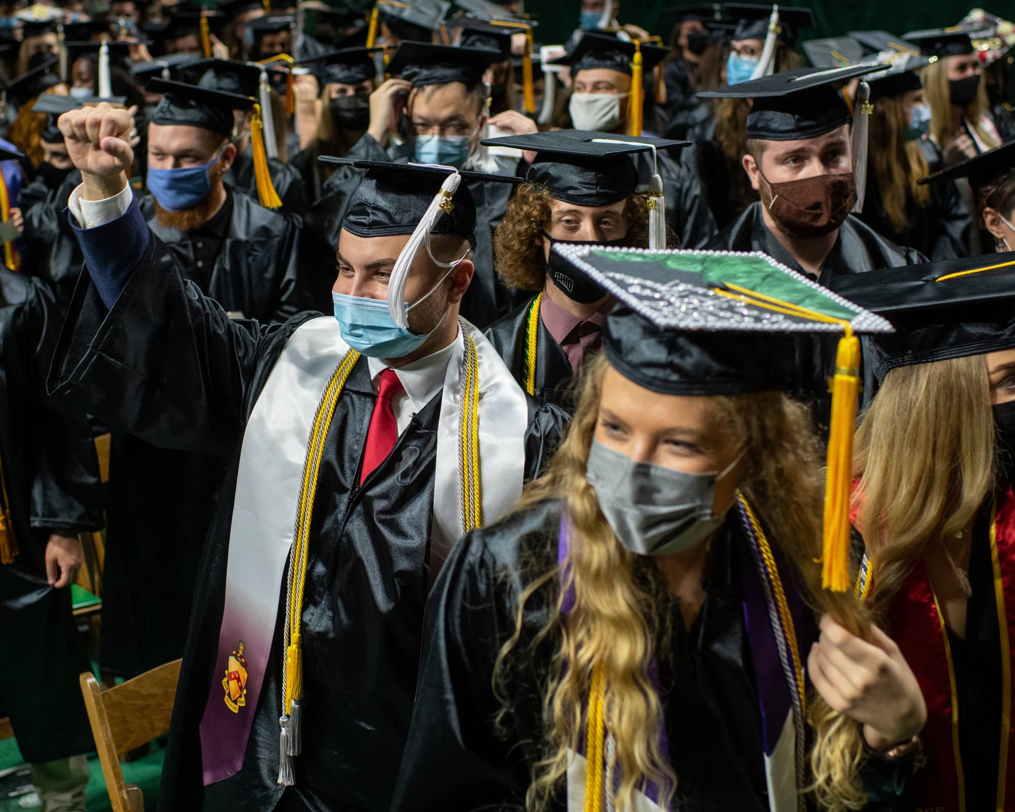 Students stand and acknowledge their official graduate status during Fall Commencement 2021 at the Athens Campus.