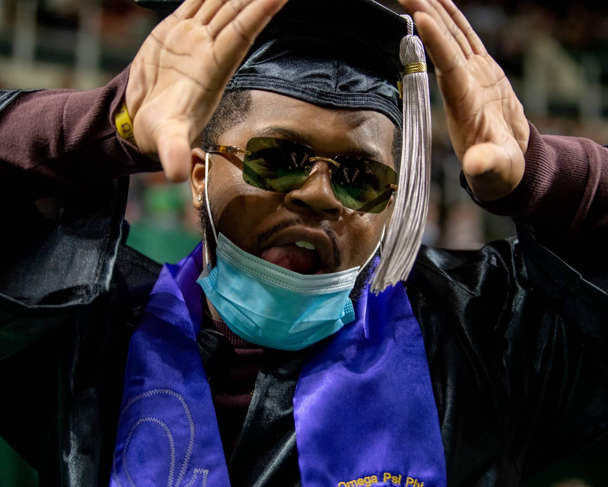 A graduate celebrates after crossing the stage during the Fall Commencement 2021 at the Athens Campus.