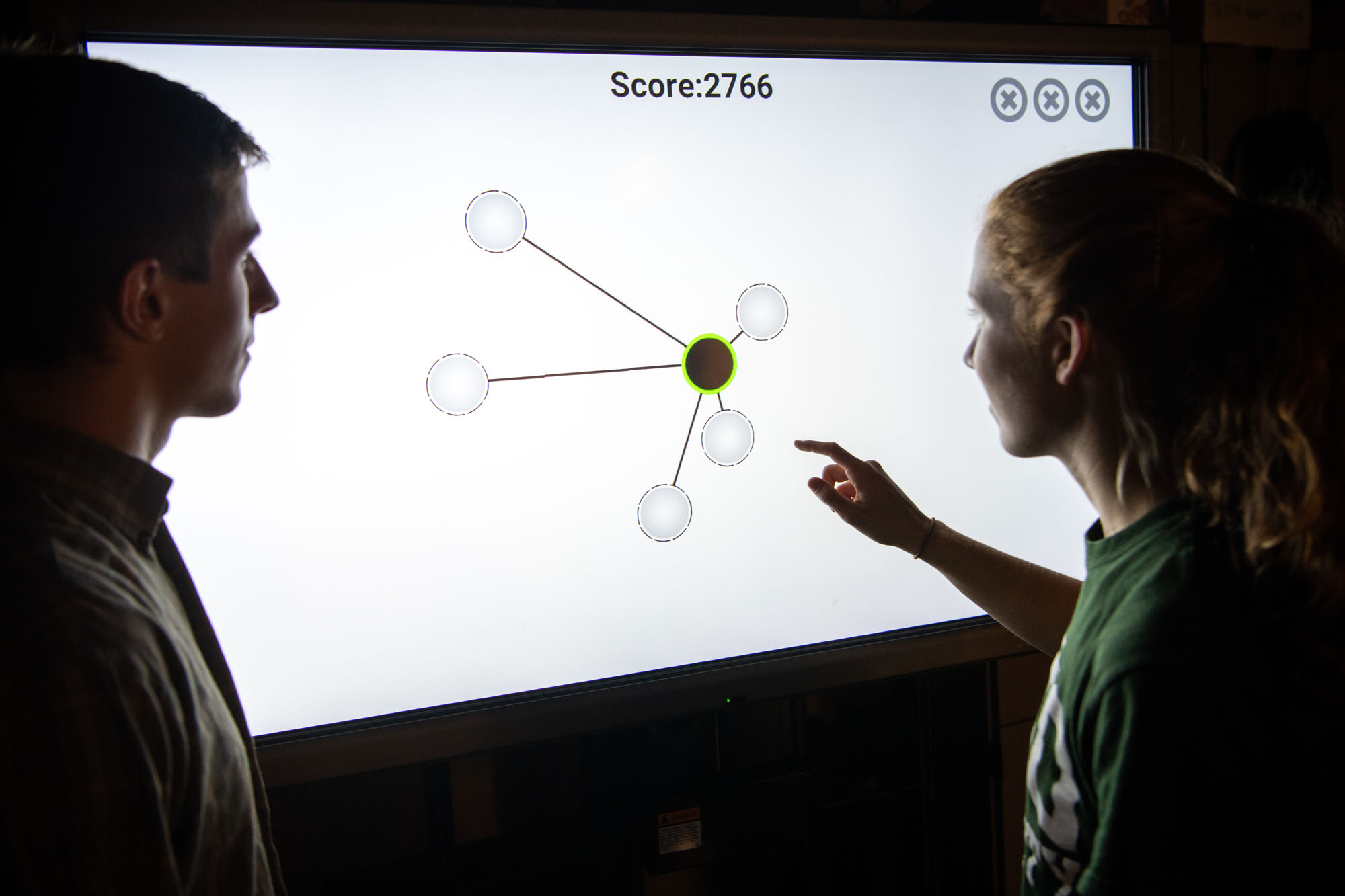 Students try out a research tool in Dustin Grooms' lab in the College of Health Sciences and Professions.