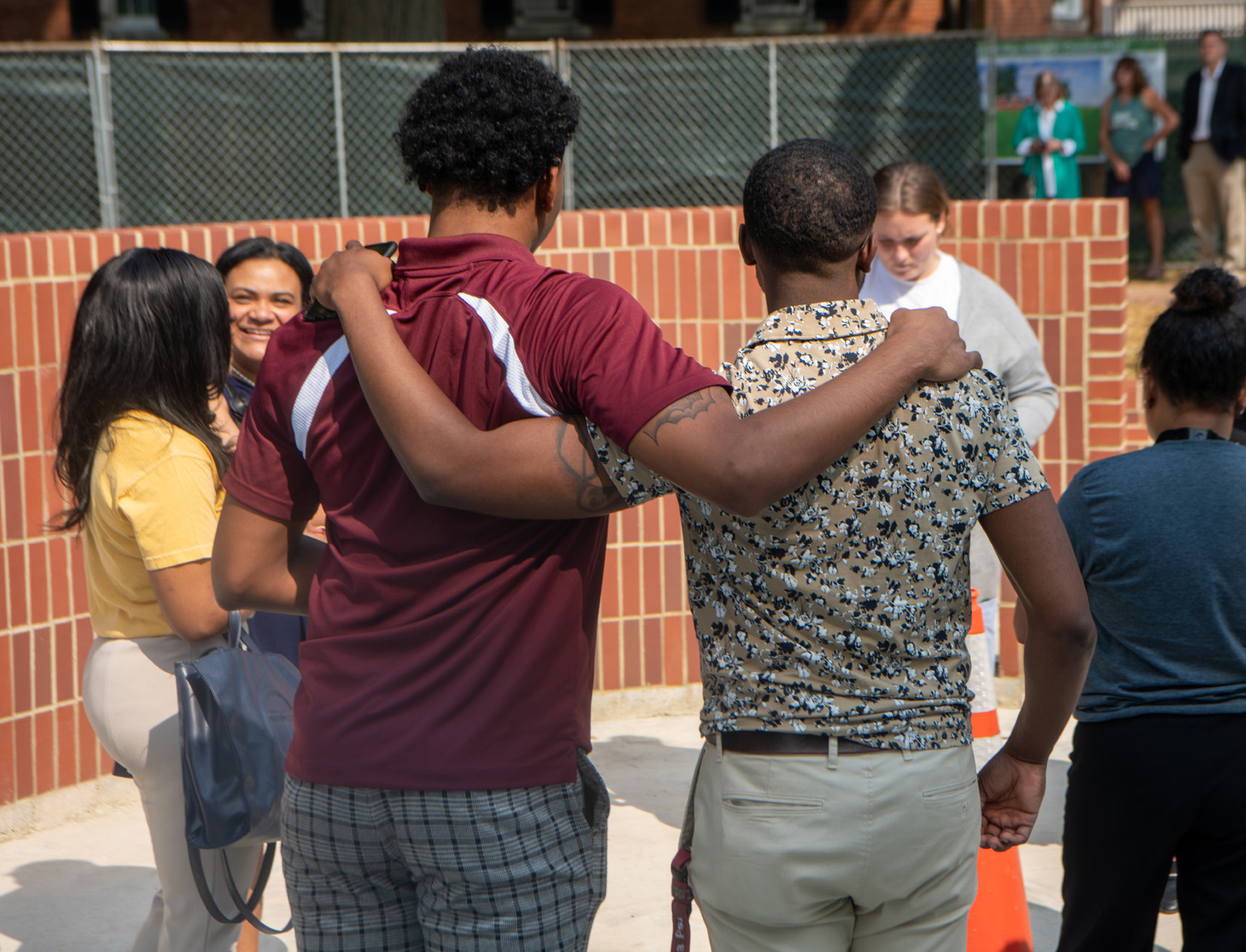 Students wait for the start of a dedication ceremony for a new monument recognizing the history of the National Pan-Hellenic Council at Ohio University.