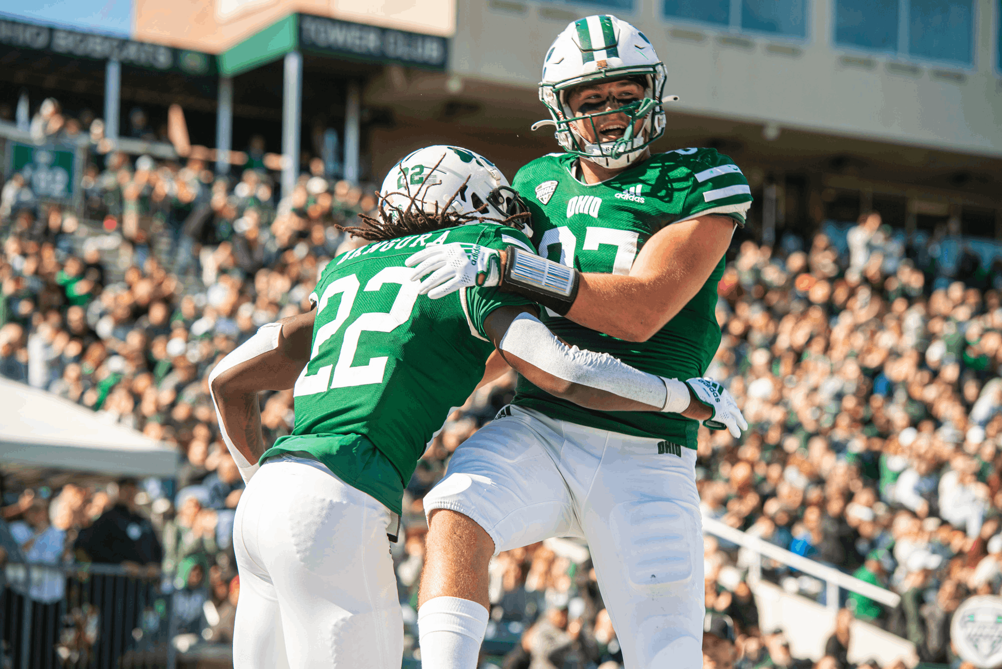 OHIO Football players, sporting throwback helmets in honor of Homecoming, celebrate a big, 55-34 win over the Akron Zips at a sold-out Peden Stadium.