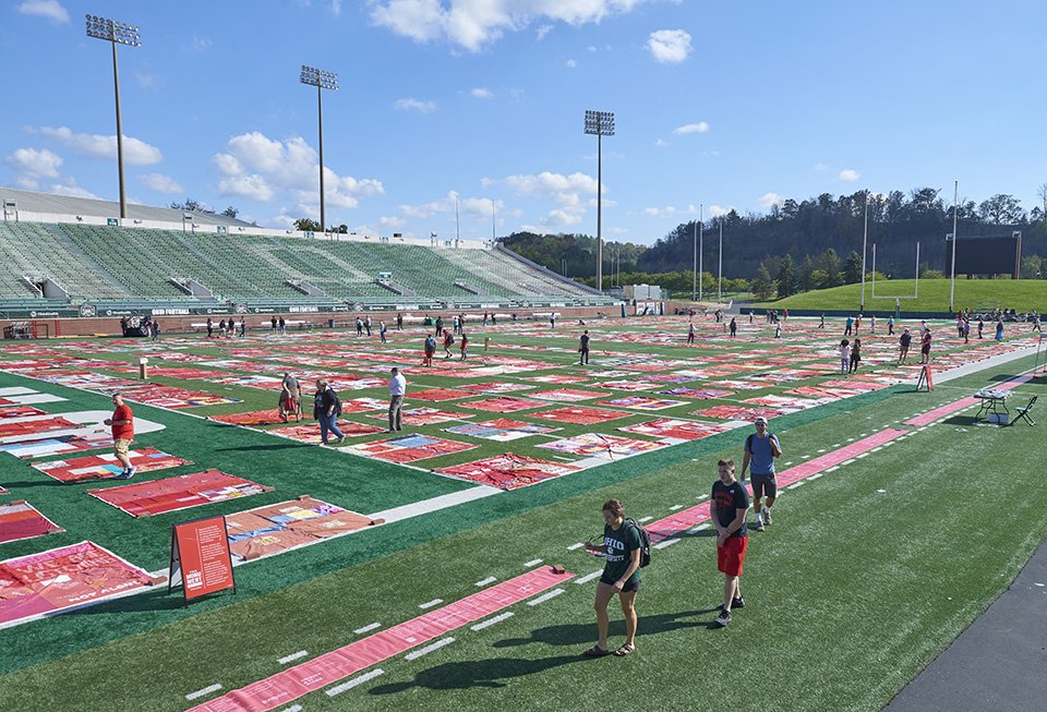 In October, more than one thousand sexual assault and abuse survivors and allies gathered at OHIO’s Peden Stadium to view The Monument Quilt, a public healing space by and for survivors of sexual assault. The occasion marked the first time the quilt has been displayed in its entirety on a college campus. Photo by Evan Leonard