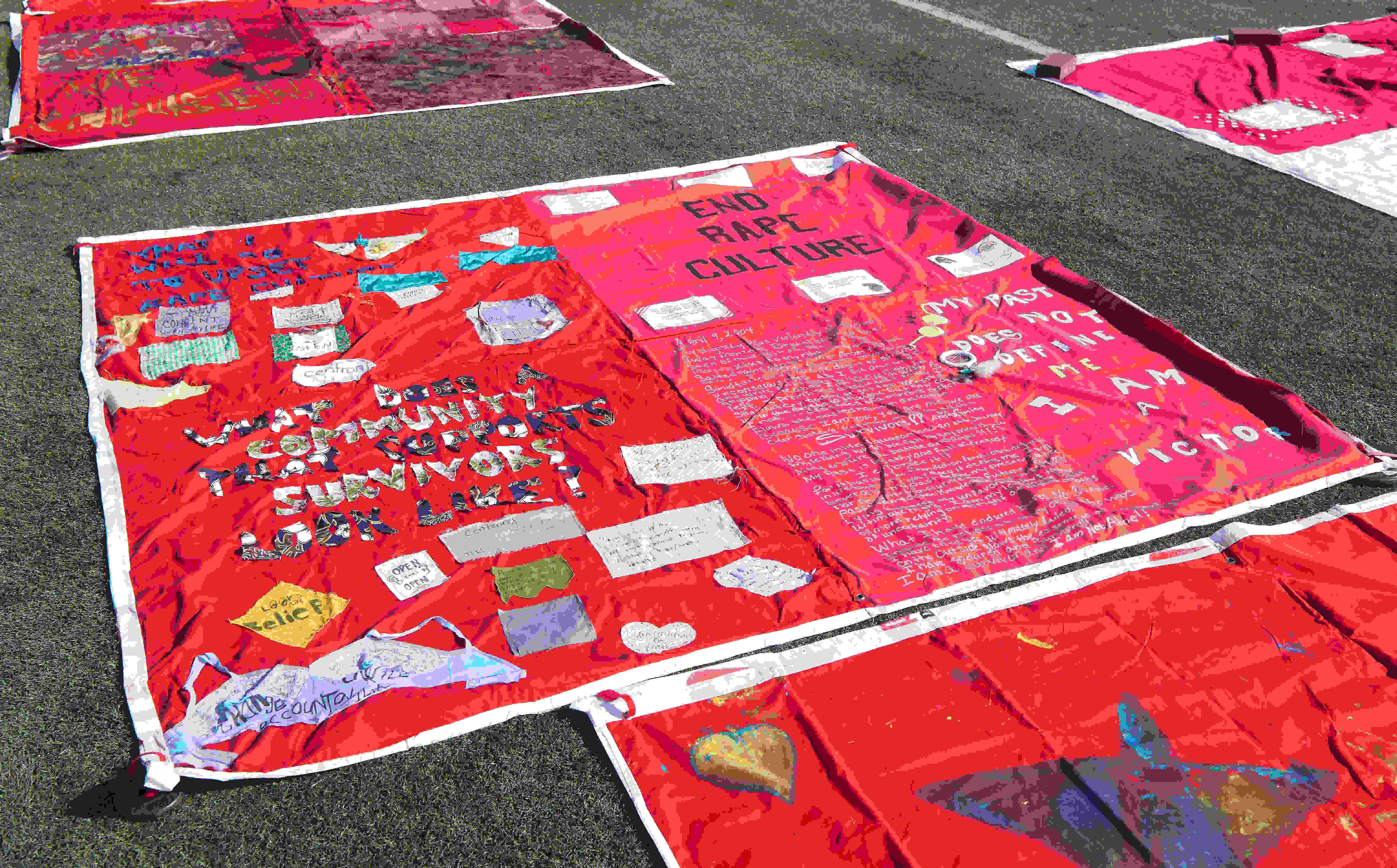 The Monument Quilt is an ever-evolving collection of stories that are written, stitched, and painted onto red fabric to commemorate and empower victims of sexual abuse. Photo by Evan Leonard