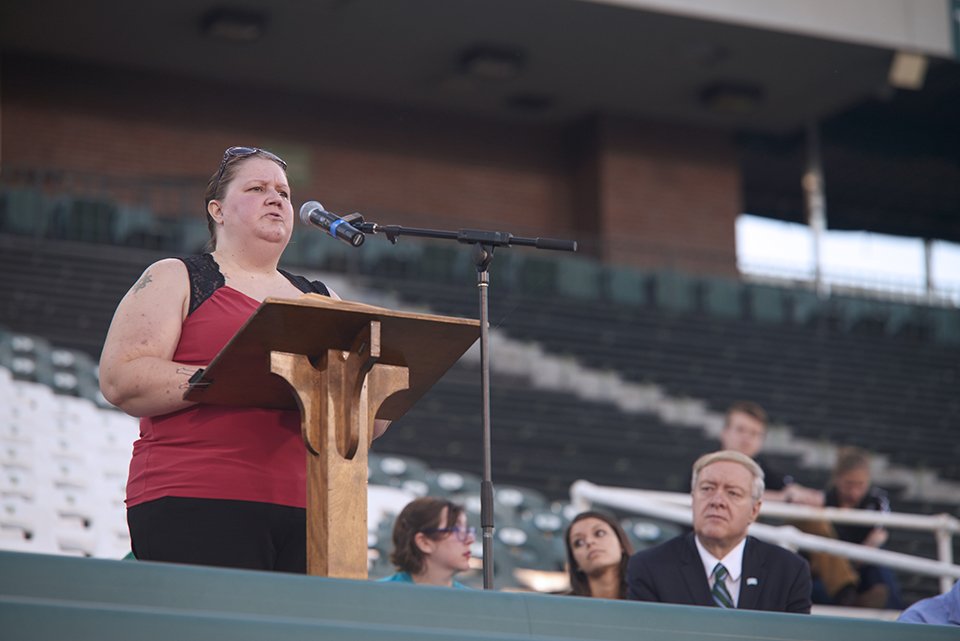 Andrea Neutzling, a survivor of sexual assault she suffered while serving in the military, shares her experiences with the crowd, including with OHIO President M. Duane Nellis, right. Photo by Evan Leonard