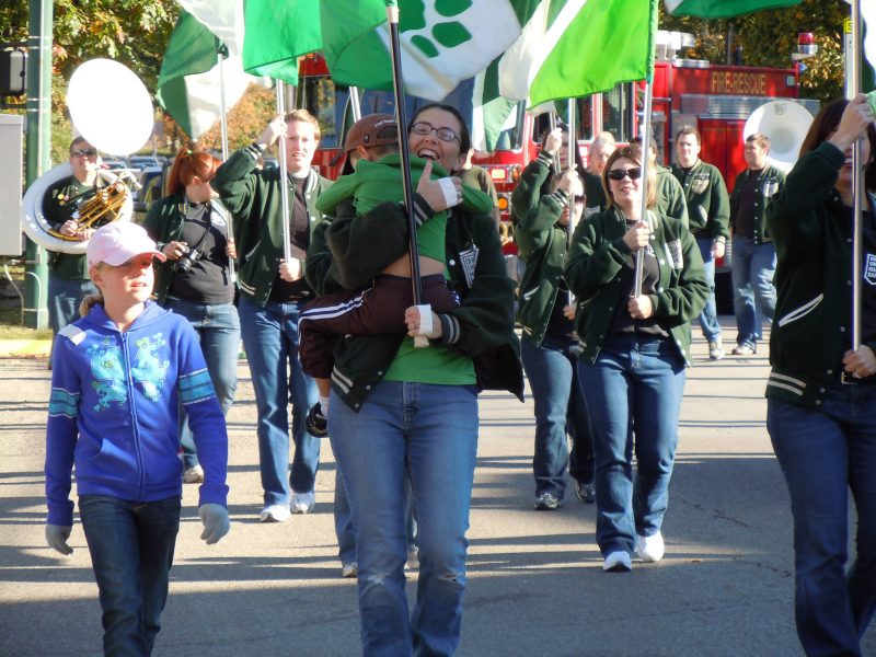 Bowie marching in the 2010 Homecoming Parade with her 5 year old son in her arms