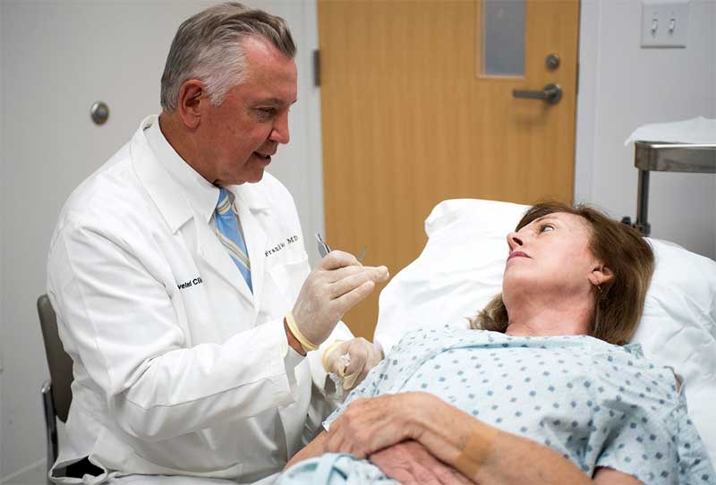 Doctor Frank Papay consults with Melanie before performing a procedure at the Cleveland Clinic.