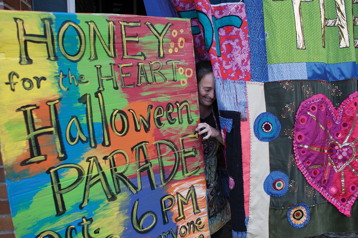 Executive director of Athens-based Passion Works, Patty Mitchell, BFA ’87, throws a knowing smile in anticipation for the Honey for the Heart parade to begin. Photo by Michael Johnson, BSVC ’19