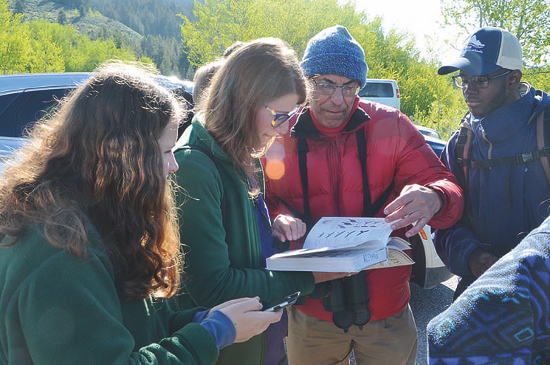 Ralph Haberfeld helps students identify an osprey at Oxbow Bend
