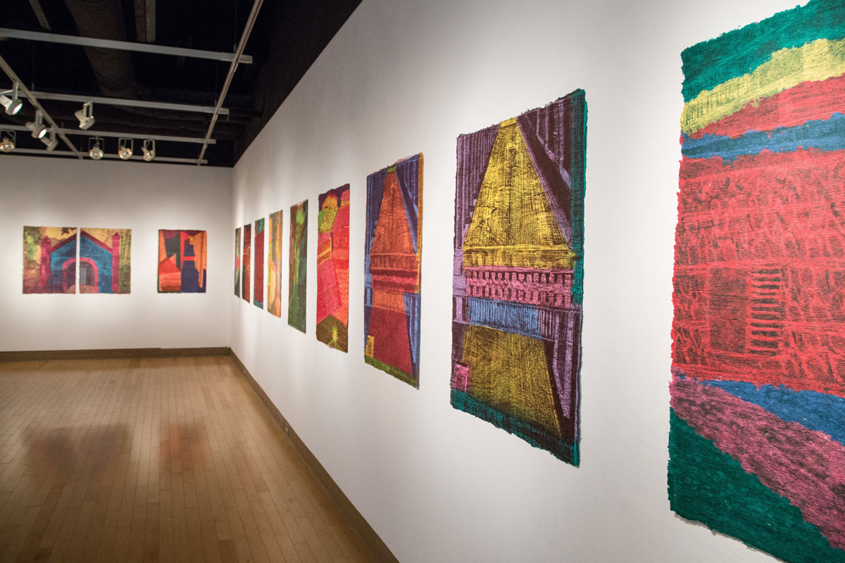Manusos described this series of prints as architectural forms, created using the woodblock printing process on hand-poured paper. The work in the exhibition represented her “own personal, temporal response to life, using layers of liquid colored paper pulp, paint, and printed images.”