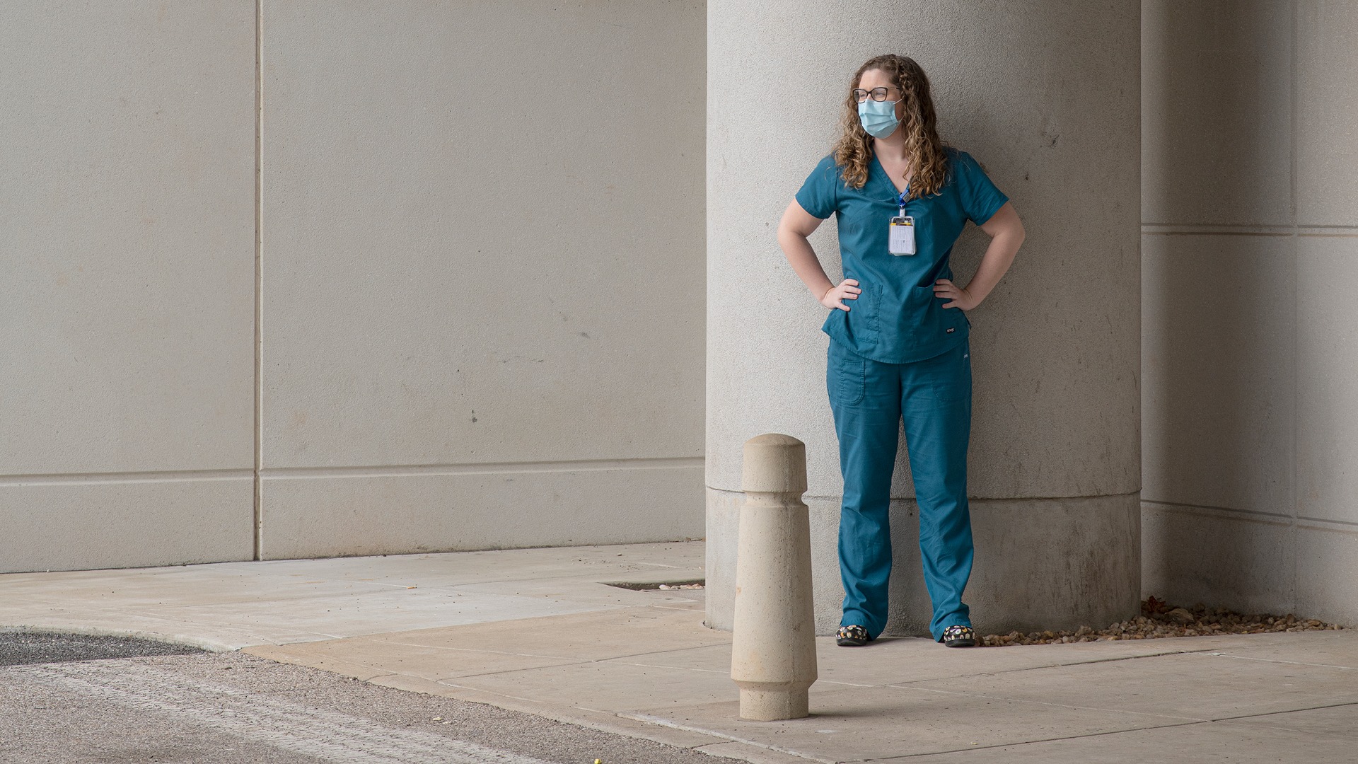 Women standing in scrubs outside of a building