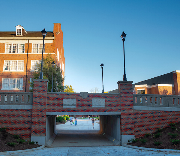 View of the bridge facing Porter Hall. Students are about to walk underneath of it