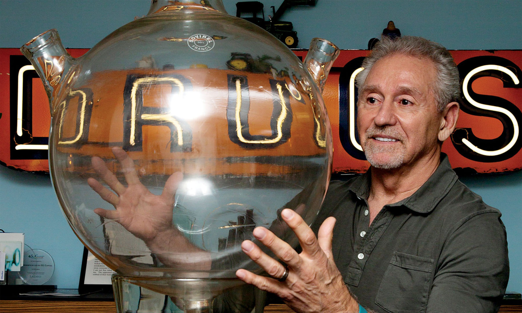 Rick Hawkins’ office tells his life story—from a tractor reminiscent of his rural Ohio upbringing to a drugstore sign. Photo by Pu Ying Huang