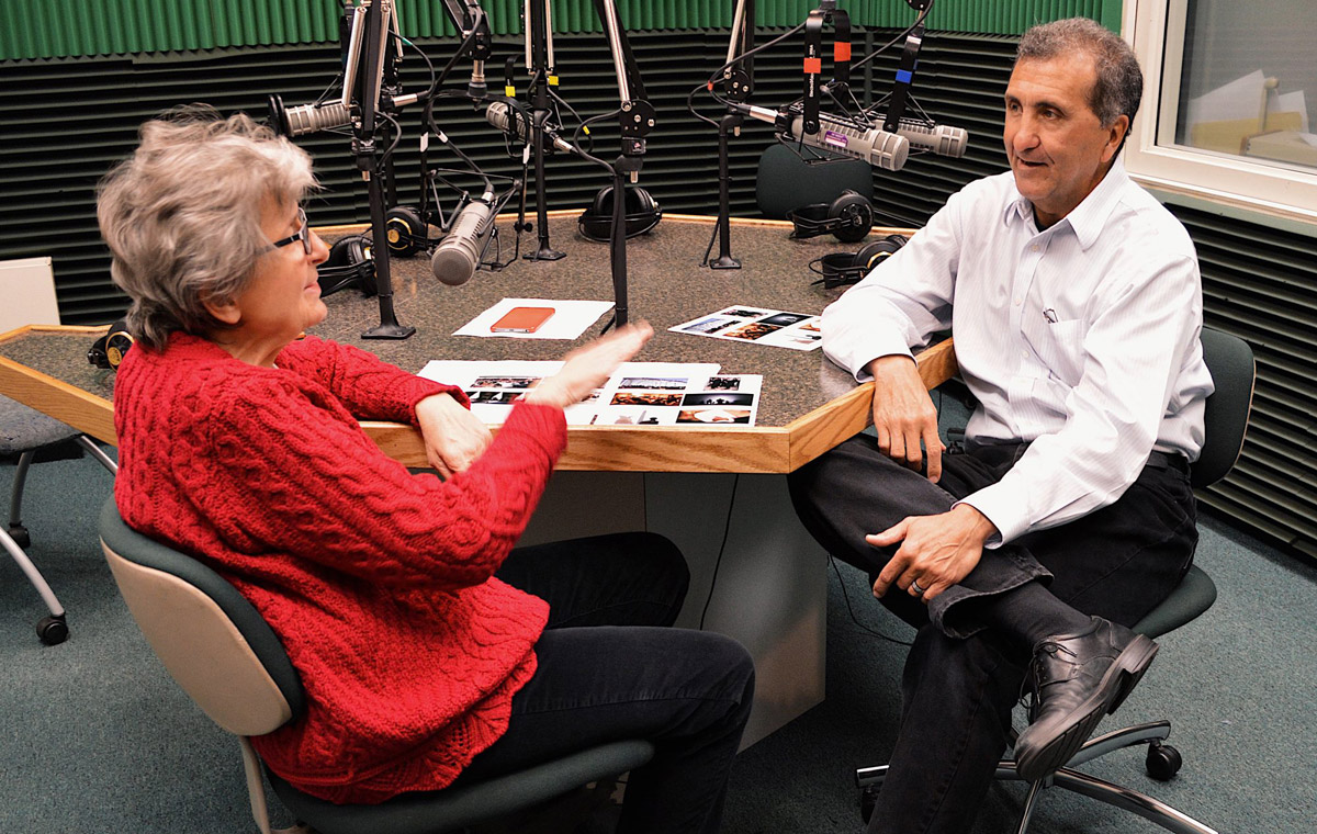 Pete Souza sitting at a table with former colleague Marcia Nighswander, conducting a radio interview