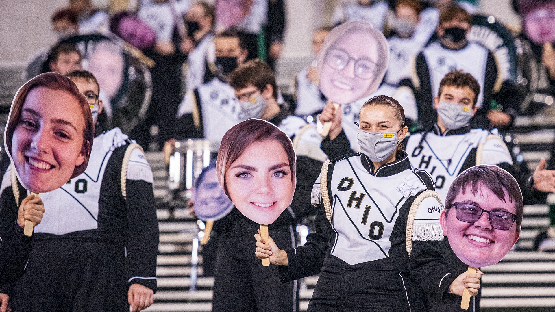 Marching 110 members hold up their bandmates images