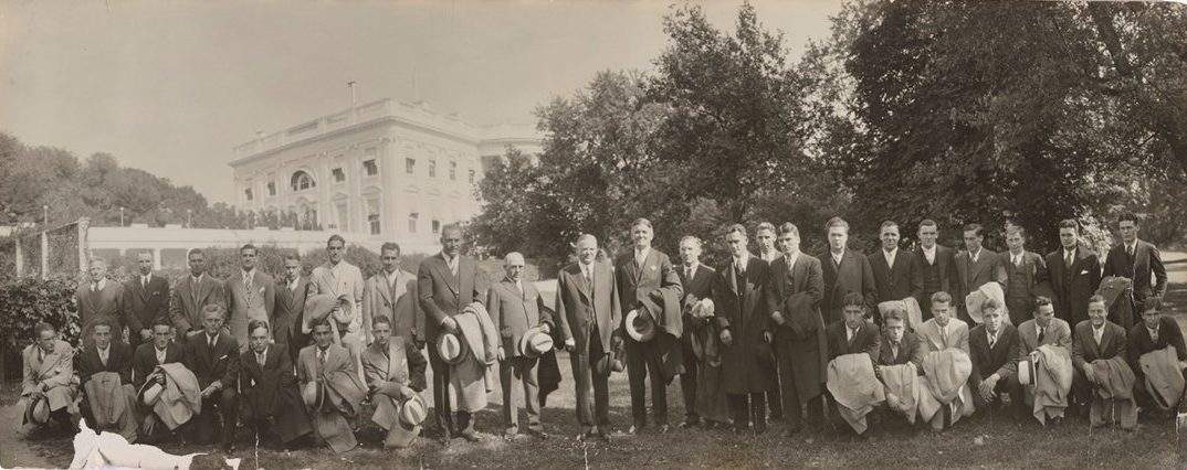 In this image, OHIO’s 1932 football team stands for a photo with President Herbert Hoover the day before the game against Navy. 
